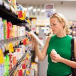 Woman shopping personal hygiene products at supermarket.