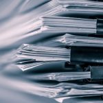 the extreamely close up  report paper stacking of office working document , retro color tone