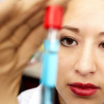 Lab technician with a vial